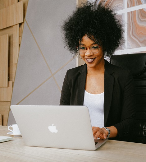 woman using macbook in office