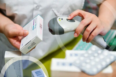 pharamcist scanning serial number on package of pills