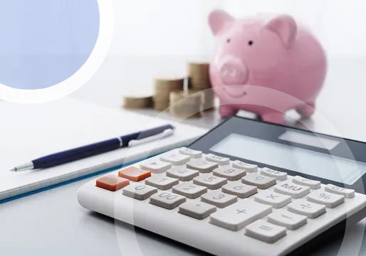 piggy bank next to calculator and pen