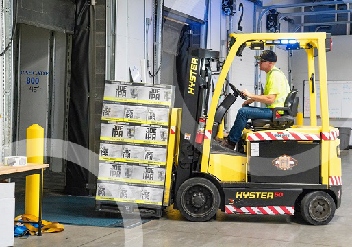 yellow forklift loading IPA beer onto truck