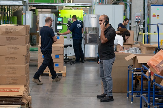 man on phone in factory