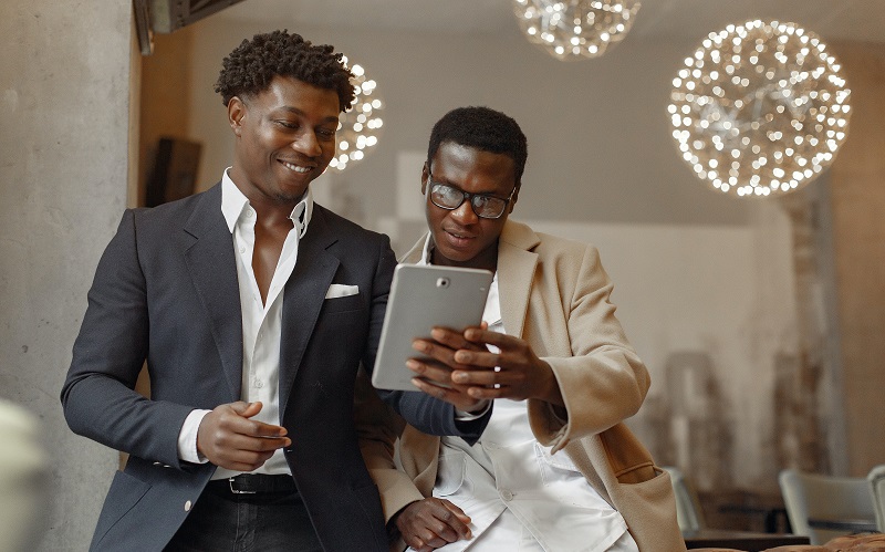 salesperson showing his tablet to a buyer