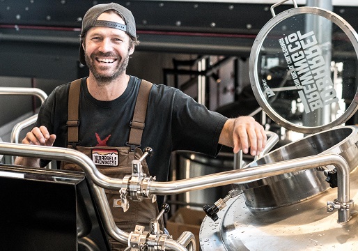 happy man working in beer brewery