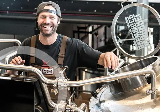 happy man working in beer brewery