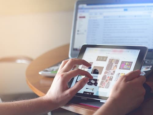 fingers scrolling on tablet device