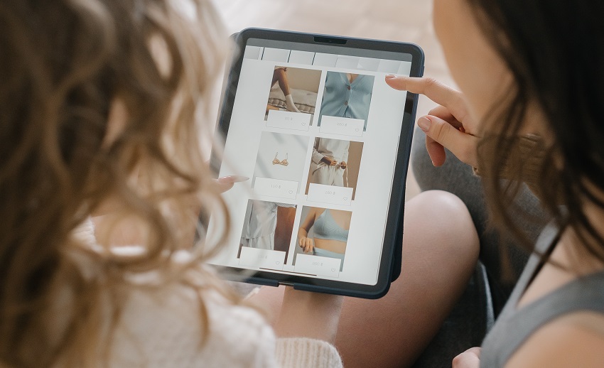 women scrolling through a tablet computer