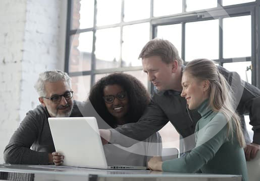 team huddled around computer
